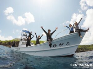 ダイビング終了後、笑顔でログ付けを楽しむ宮古島サンアイランドのお客様とスタッフ